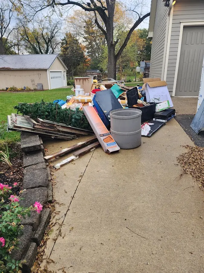 Dumpster being loaded with debris for Roofing Dumpster Rental in Helena Valley Southeast